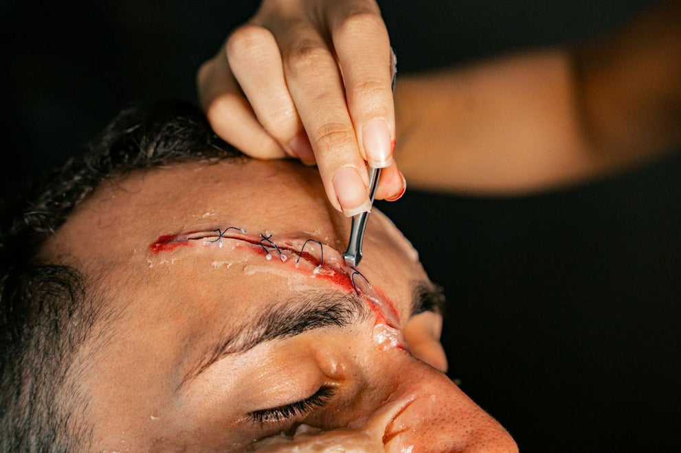 Doctor Stitching A Wound