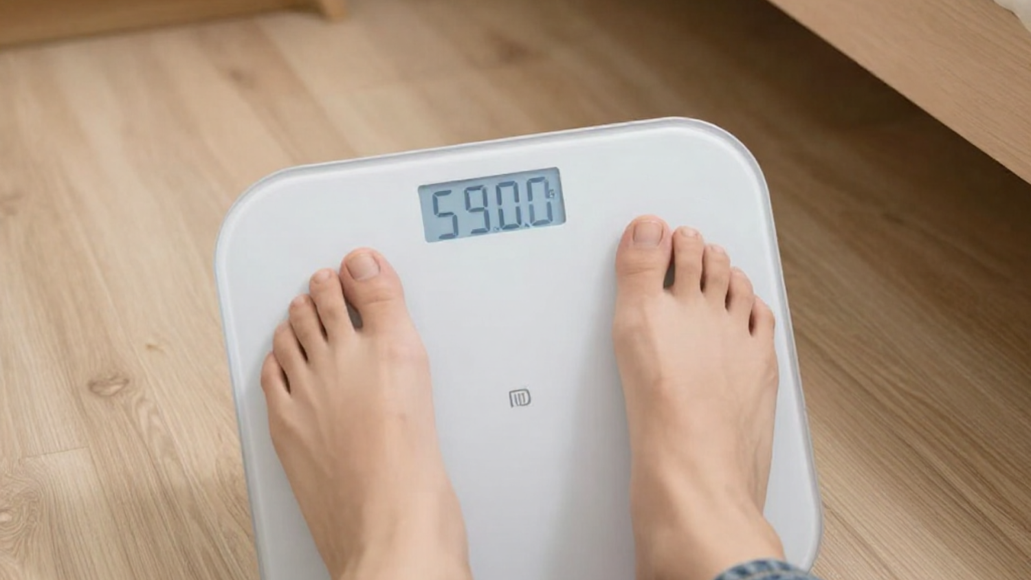 Person Stepping On Bathroom Scale Checking Weight