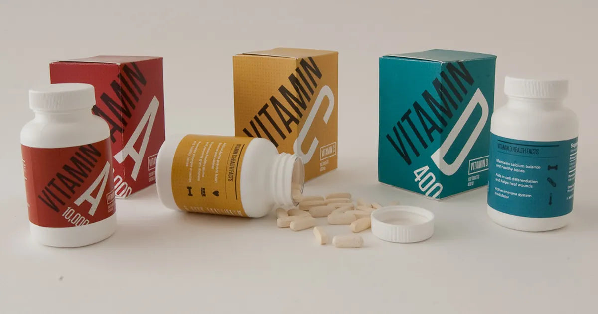 Amber supplement capsules beside a clear ingredient label and a glass of water on a bright table